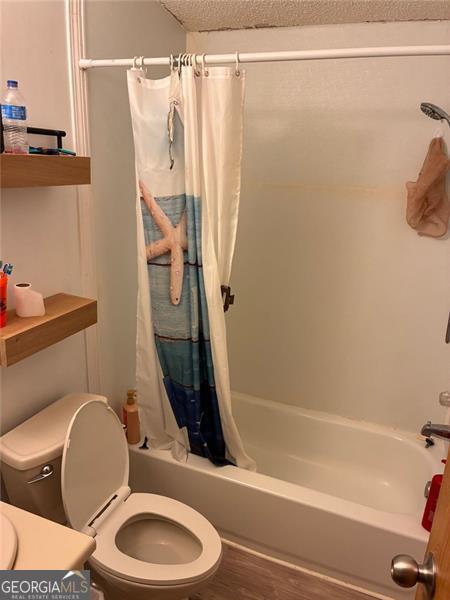 5165 Sycamore Trail, Unit 285 Buford, GA 30518 - Photo 6 of 7 a bathroom with a sink toilet and shower