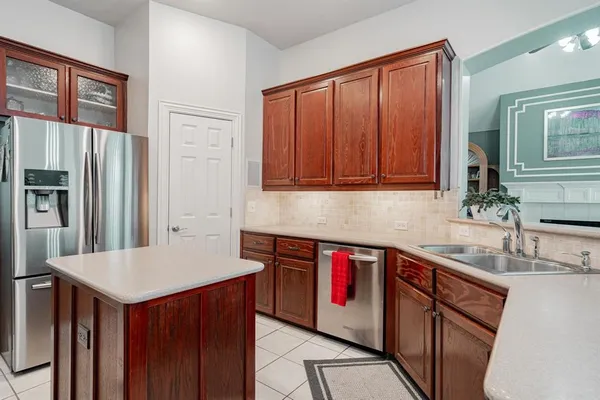 a kitchen with stainless steel appliances granite countertop a refrigerator a sink and dishwasher