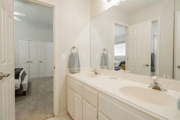 a bathroom with a double vanity sink and a mirror