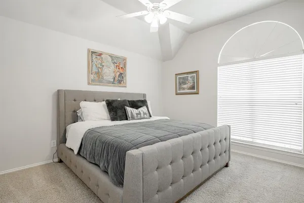 a bedroom with bed and window