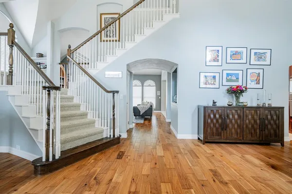 a view of entryway and hall with wooden floor