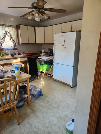 a kitchen with a sink and a refrigerator