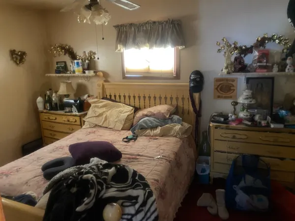 a bed room with a bed and a window