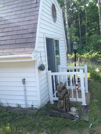 a view of front door and small yard