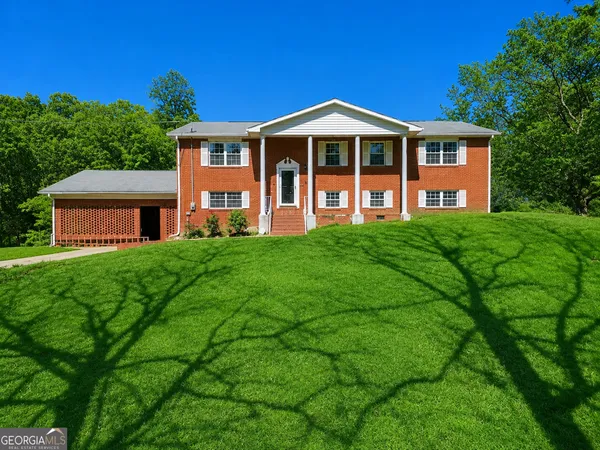 a front view of a house with a yard