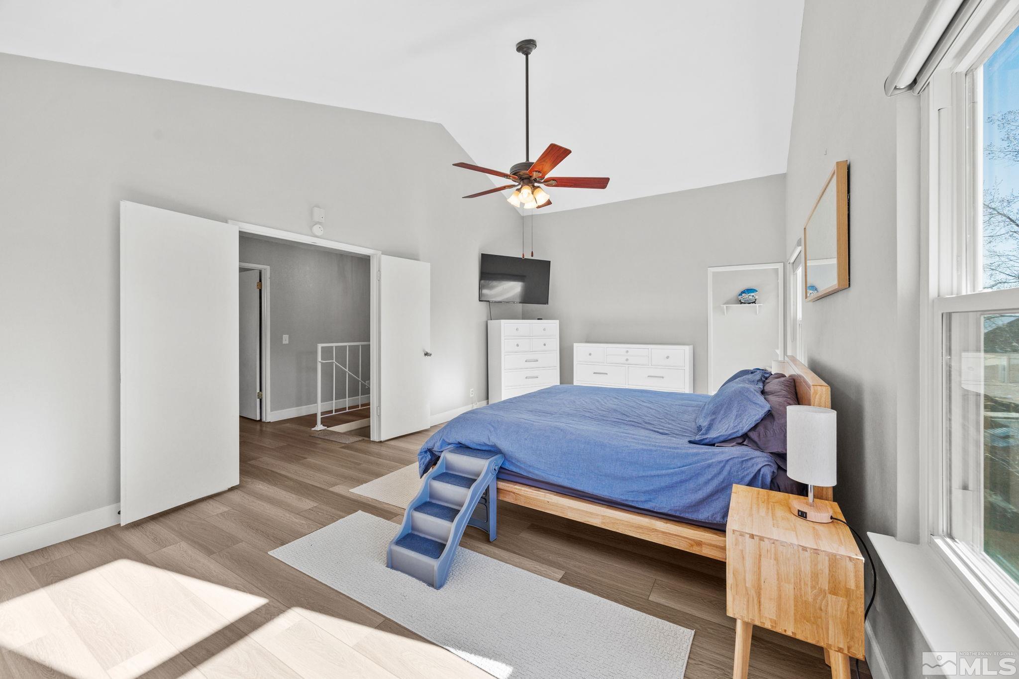 3829 Kings Row Reno, NV 89503 - Photo 28 of 40 a bedroom with a bed and a chandelier