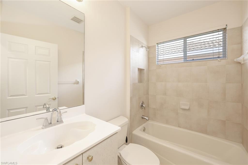 20411 Rookery Drive Estero, FL 33928 - Photo 15 of 29 Full bathroom with toilet, tiled shower / bath combo, and vanity