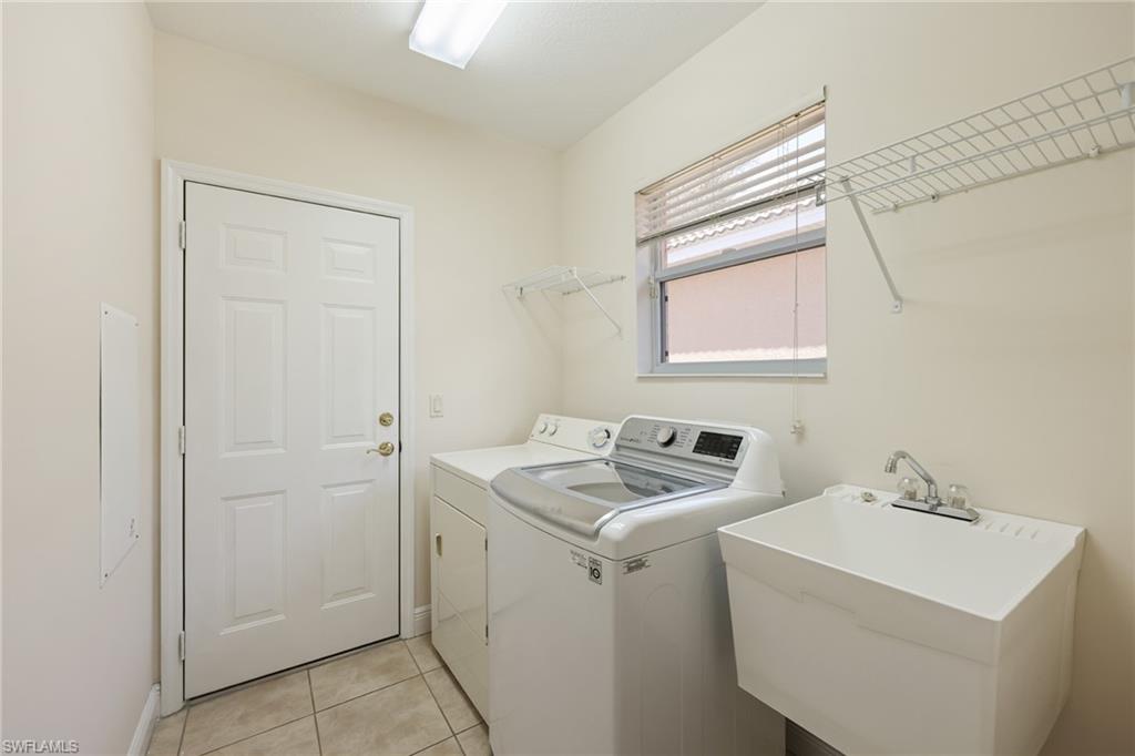 20411 Rookery Drive Estero, FL 33928 - Photo 16 of 29 Clothes washing area featuring sink, separate washer and dryer, and light tile patterned floors