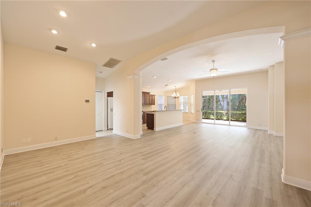 20411 Rookery Drive Estero, FL 33928 - Photo 4 of 29 Unfurnished living room with light hardwood / wood-style floors and ceiling fan with notable chandelier