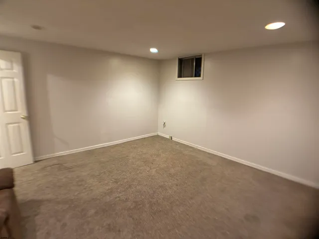 an empty room with a empty space and windows