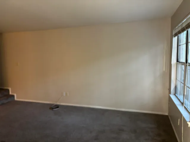 a view of an empty room and a window