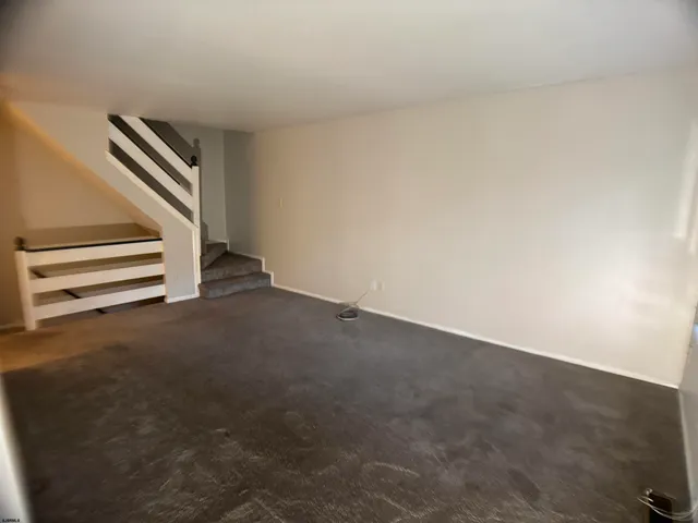 a view of an empty room with stairs
