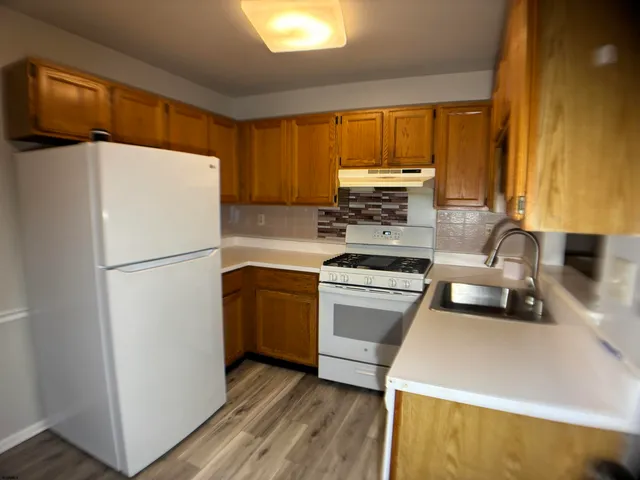 a kitchen with a refrigerator sink and stove