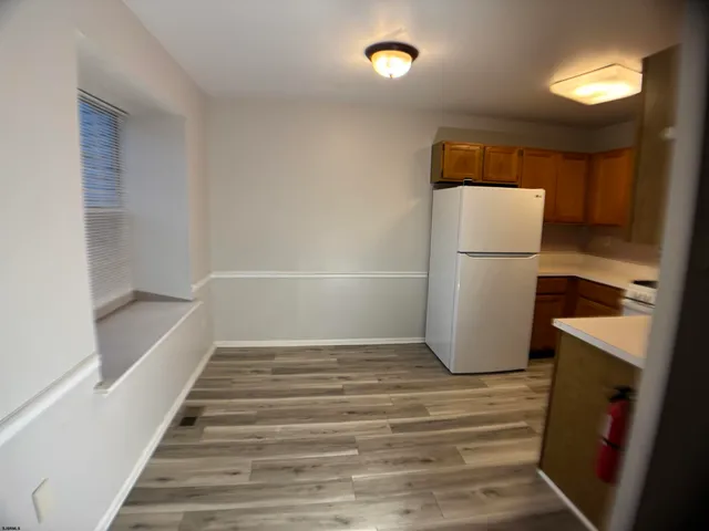 a view of a closet and wooden floor in a room