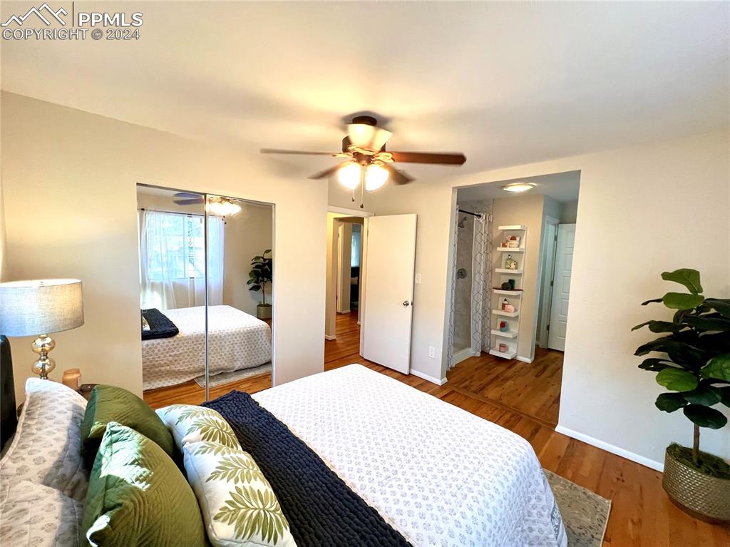 929 Sunset Road Colorado Springs, CO 80909 - Photo 26 of 45 a bedroom with bed and a chandelier