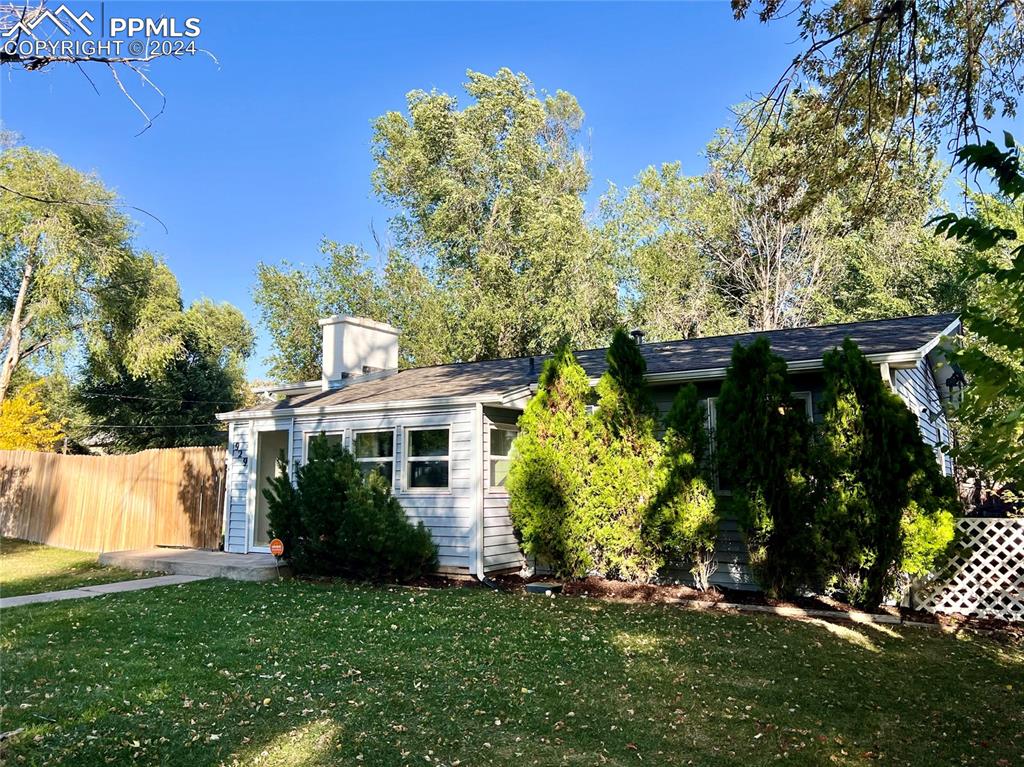929 Sunset Road Colorado Springs, CO 80909 - Photo 5 of 45 front view of a house with a yard