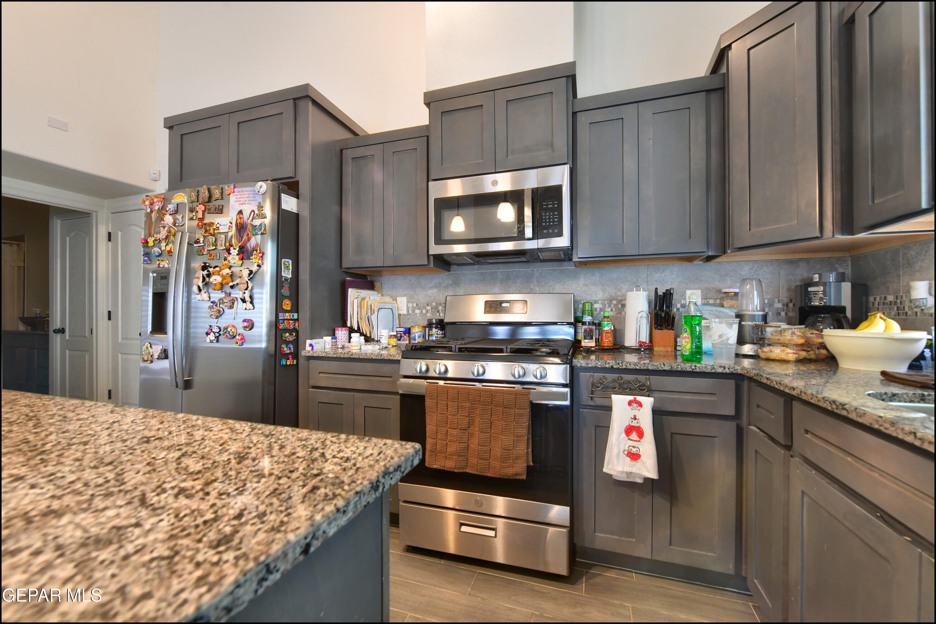 235 Herts Way El Paso, TX 79928 - Photo 14 of 35 a kitchen with stainless steel appliances granite countertop a sink stove and refrigerator