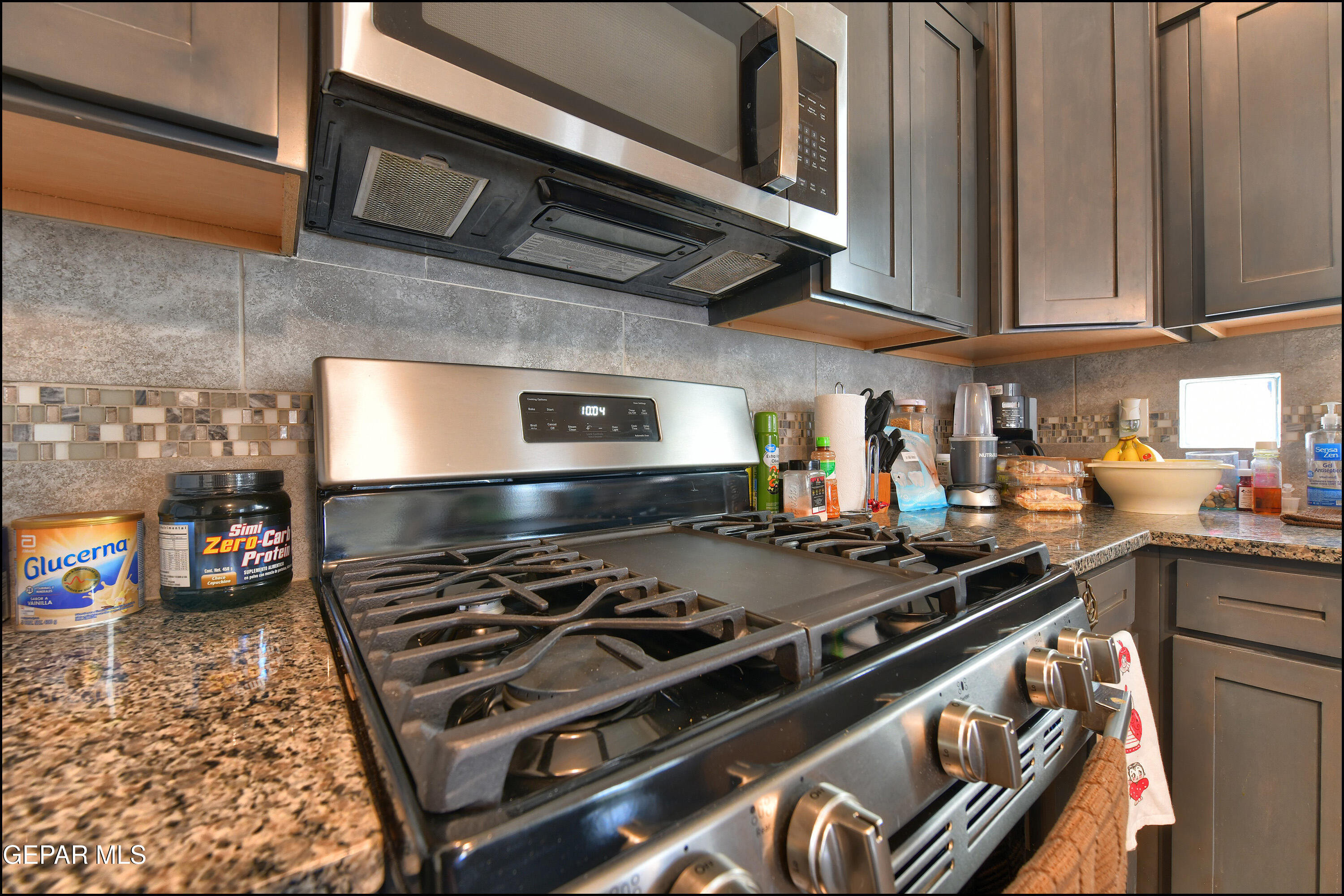 235 Herts Way El Paso, TX 79928 - Photo 16 of 35 a kitchen with a stove and a microwave