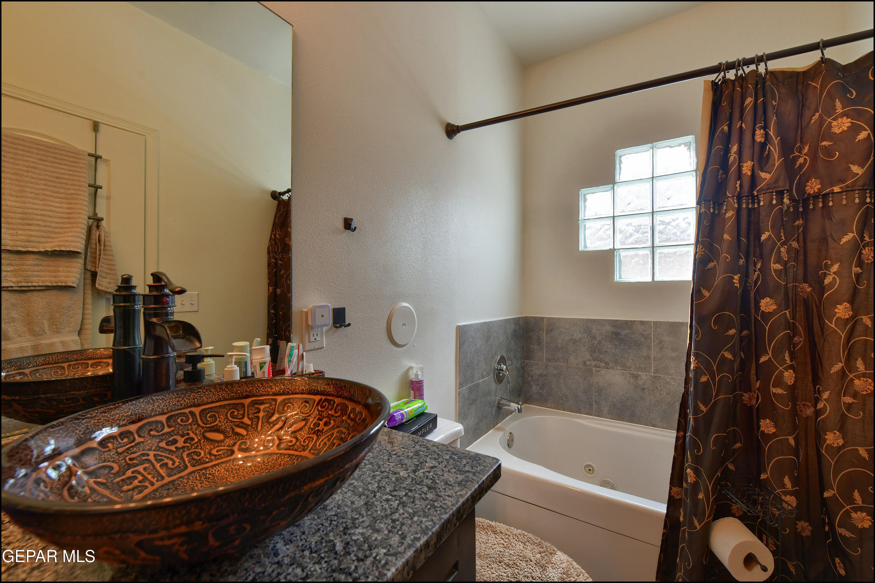 235 Herts Way El Paso, TX 79928 - Photo 20 of 35 a bathroom with a granite countertop tub and a sink