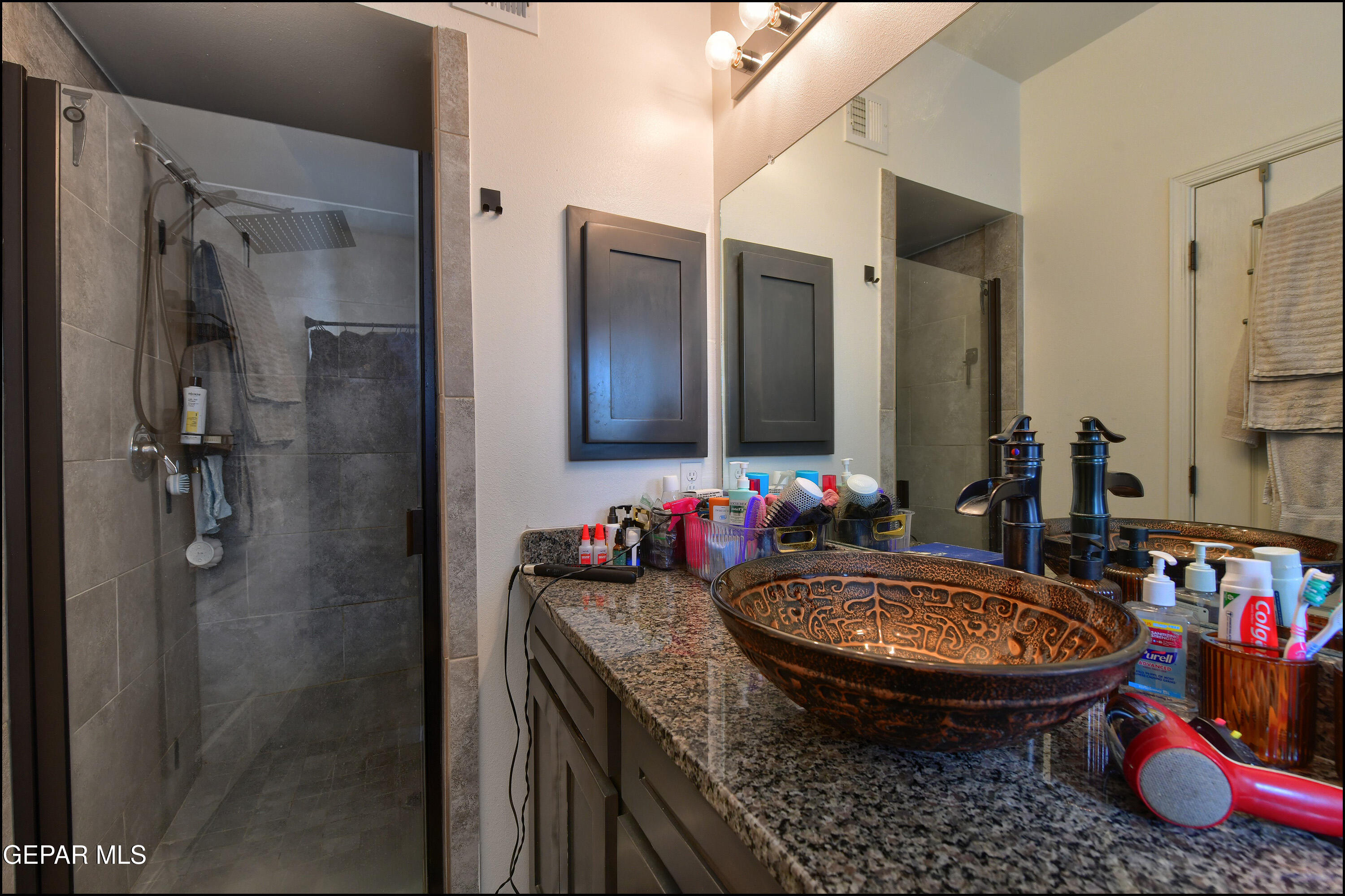 235 Herts Way El Paso, TX 79928 - Photo 21 of 35 a bathroom with a sink vanity mirror and toilet