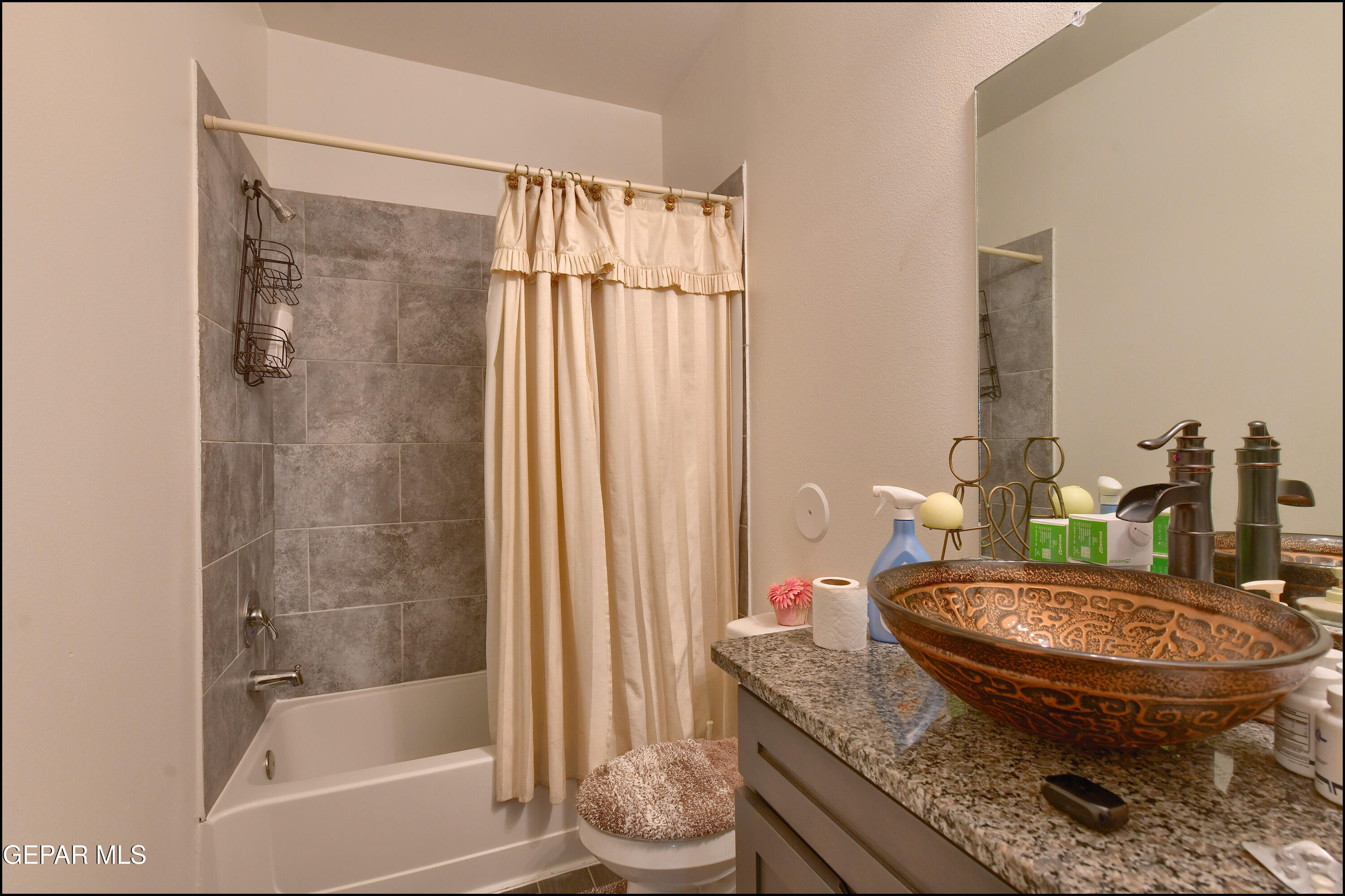 235 Herts Way El Paso, TX 79928 - Photo 24 of 35 a bath room with a granite countertop toilet and a sink