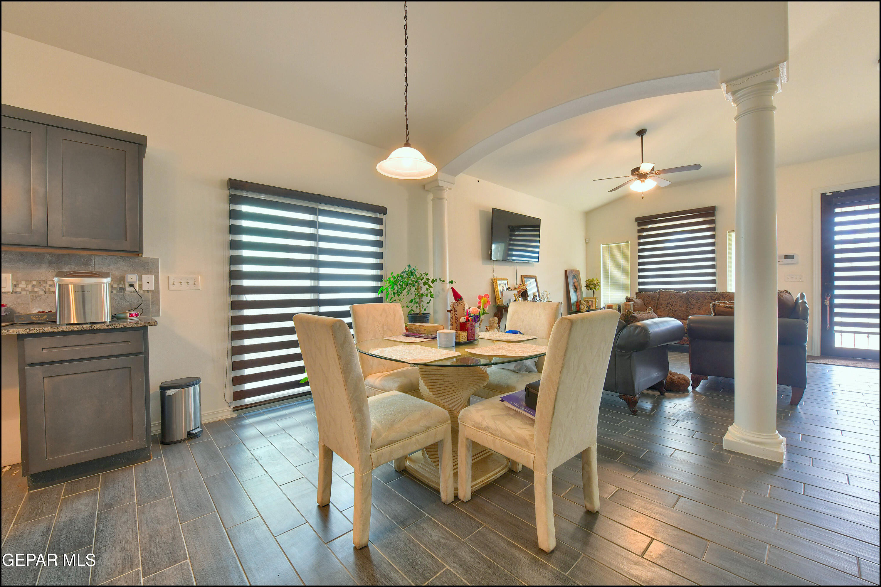 235 Herts Way El Paso, TX 79928 - Photo 10 of 35 a dining room with wooden floor a chandelier a wooden table and chairs