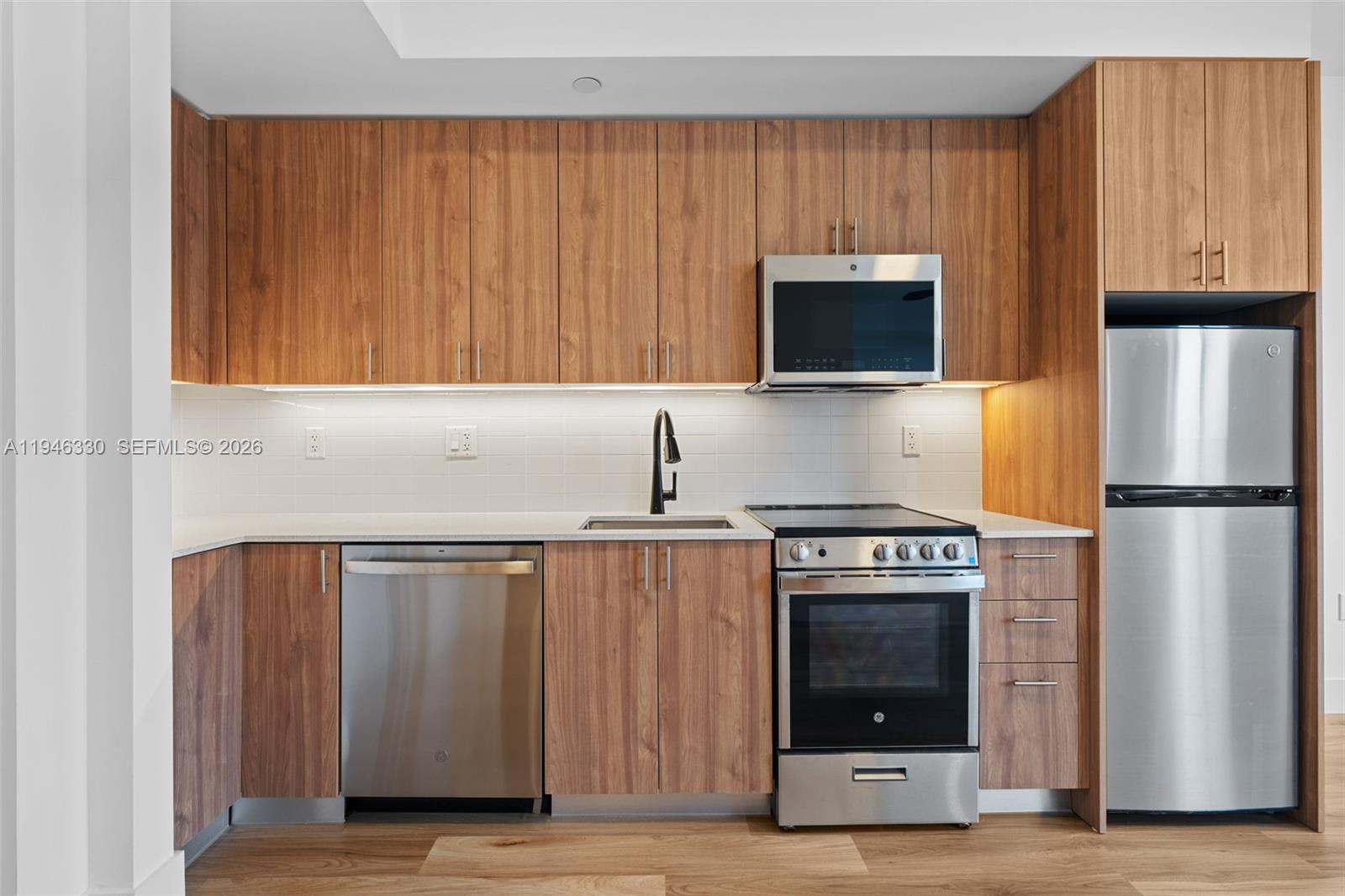 a kitchen with granite countertop a stove and a refrigerator