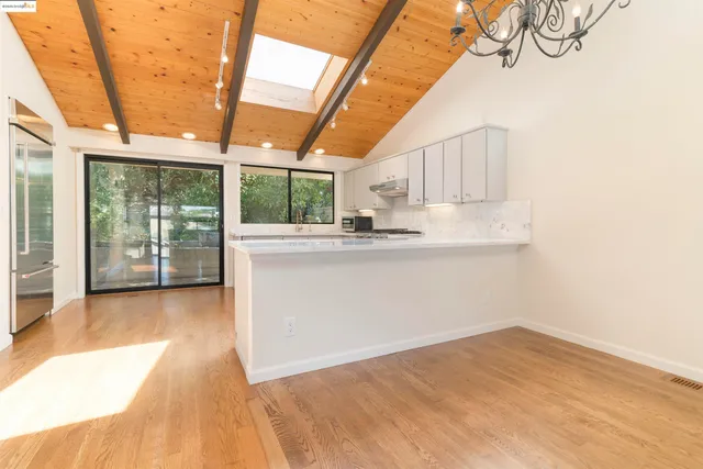 a view of a kitchen with wooden floor and iron stairs
