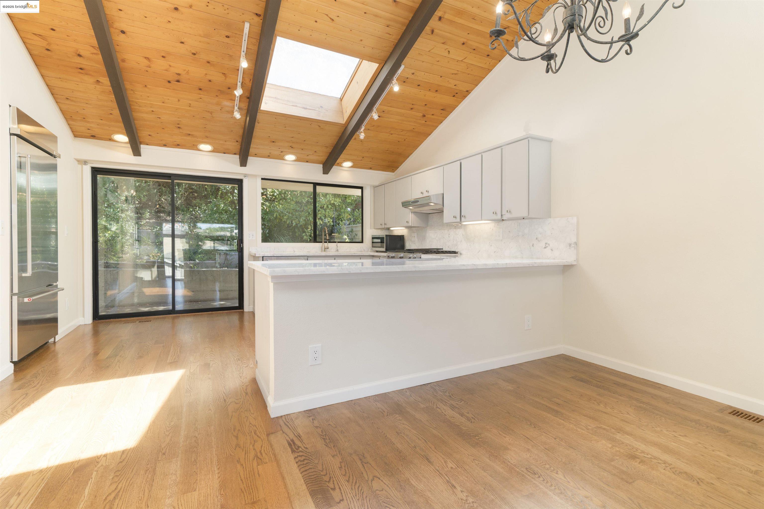 1881 Grand View Drive Oakland, CA 94618 - Photo 12 of 54 a view of a kitchen with wooden floor and iron stairs