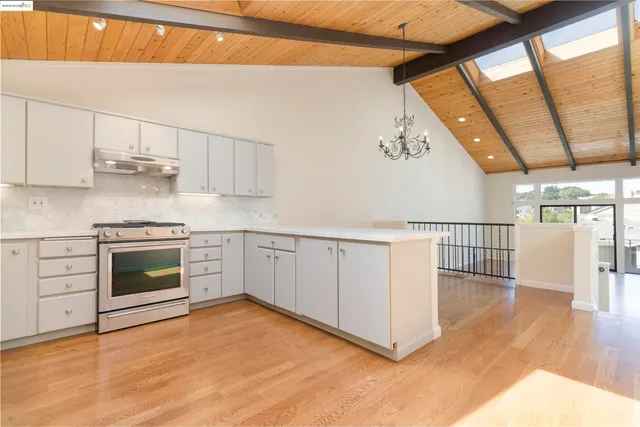 a kitchen with stainless steel appliances a stove a sink and a refrigerator