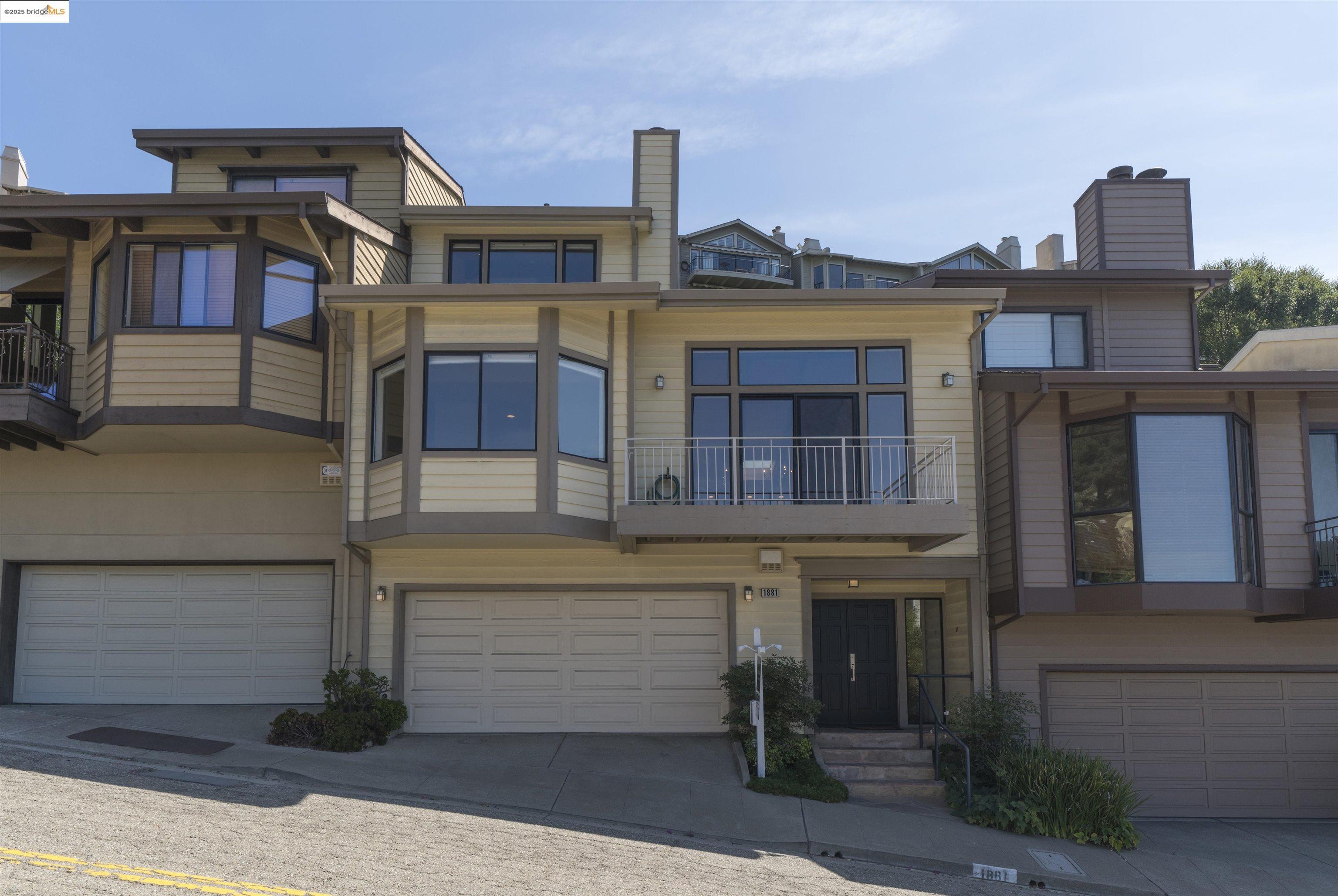 1881 Grand View Drive Oakland, CA 94618 - Photo 2 of 54 a front view of a house with a yard and garage