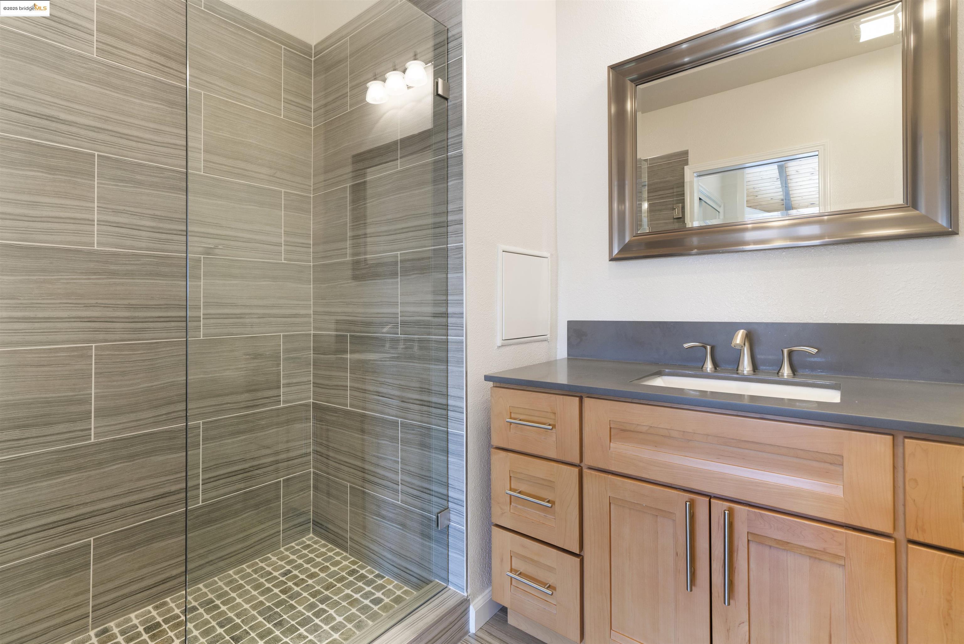 1881 Grand View Drive Oakland, CA 94618 - Photo 30 of 54 a bathroom with a sink a toilet a mirror and shower