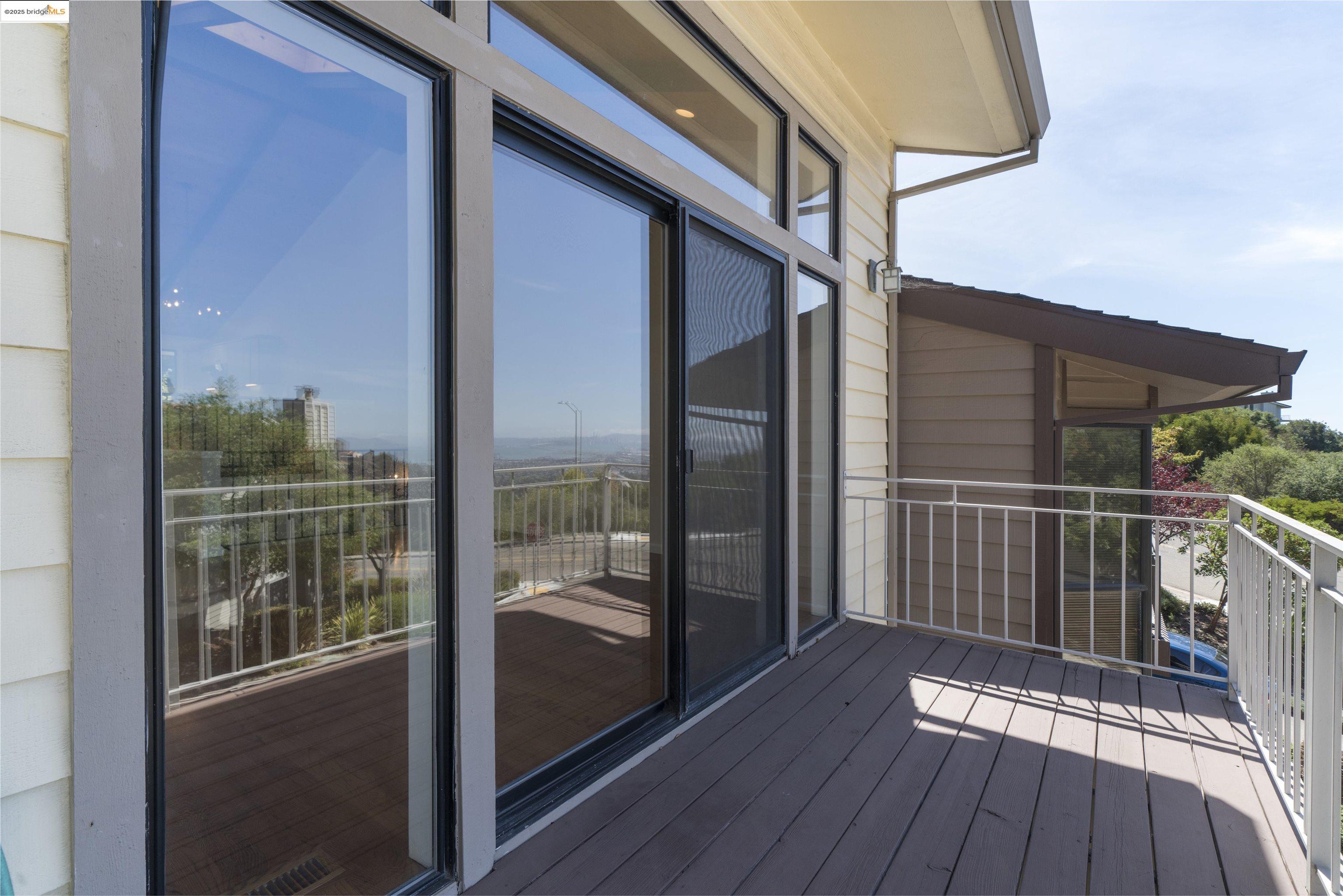 1881 Grand View Drive Oakland, CA 94618 - Photo 34 of 54 a view of balcony with floor to ceiling window wooden floor