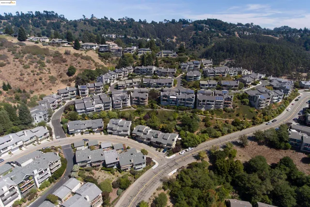 an aerial view of a house with a parking space