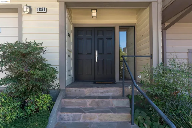 a front view of a house with plants