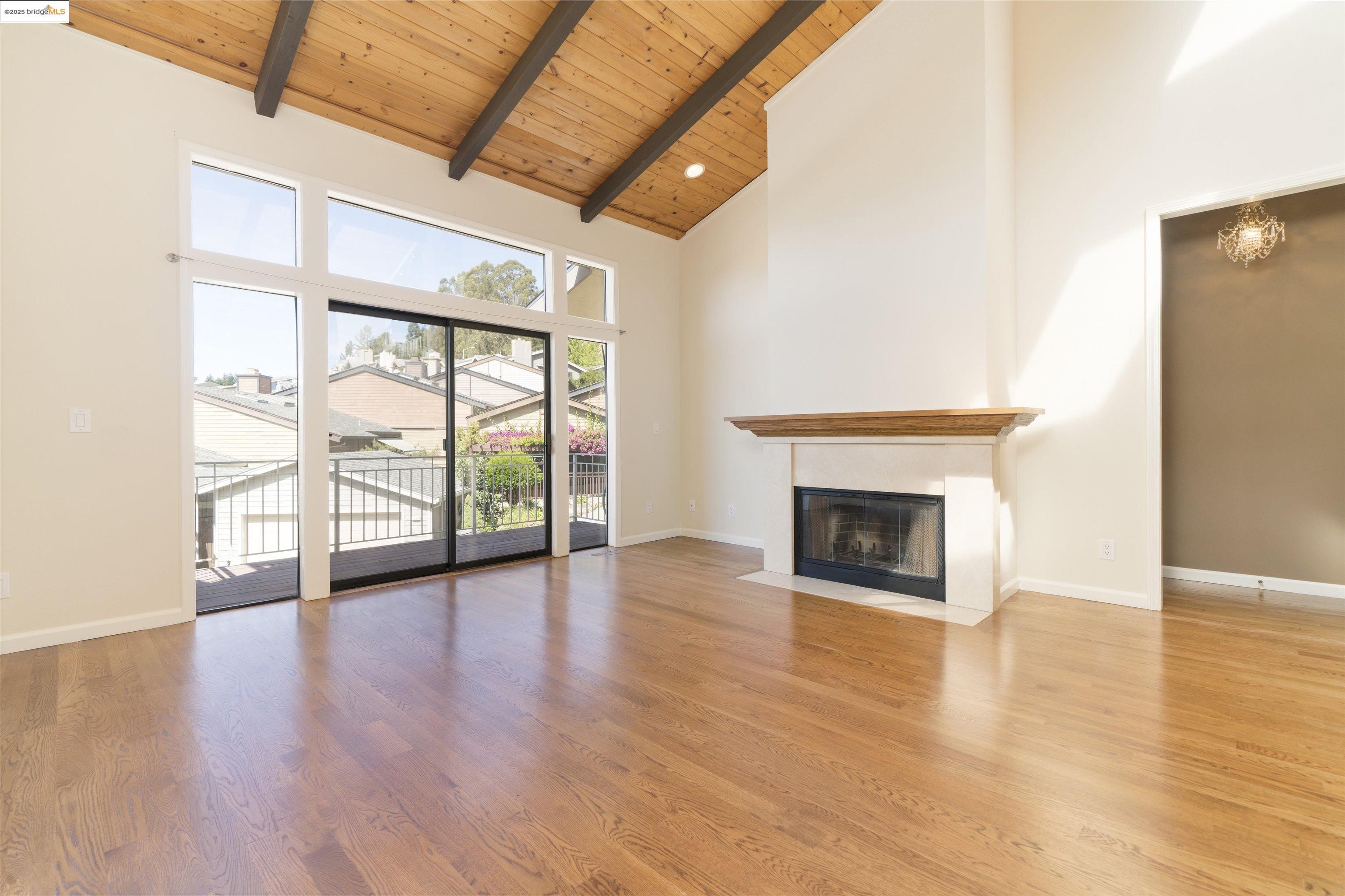 1881 Grand View Drive Oakland, CA 94618 - Photo 9 of 54 a view of an empty room with wooden floor fireplace and a window