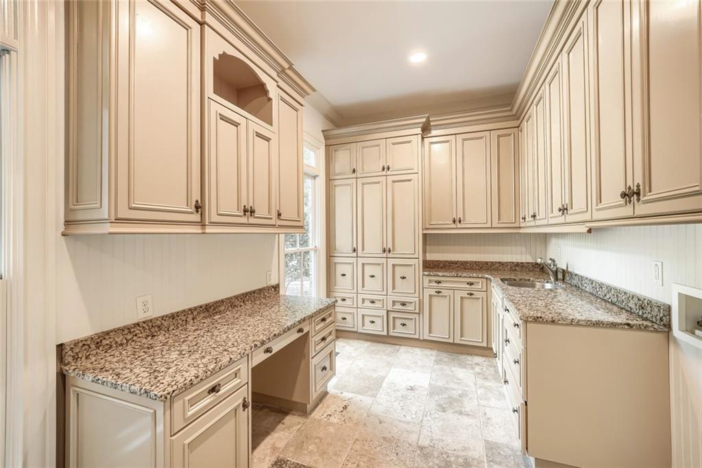 7965 Robin Road Cumming, GA 30041 - Photo 21 of 64 a kitchen with stainless steel appliances granite countertop a stove a sink and a granite counter tops