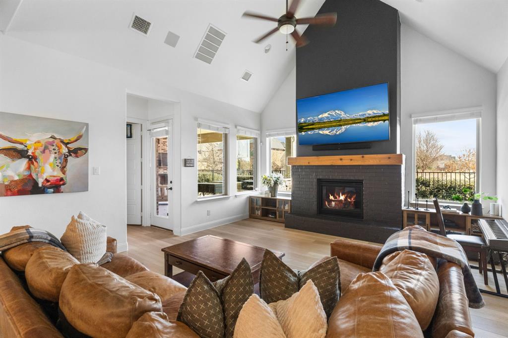 1898 Tumblegrass Road Frisco, TX 75033 - Photo 18 of 40 a living room with furniture a large window and a fireplace