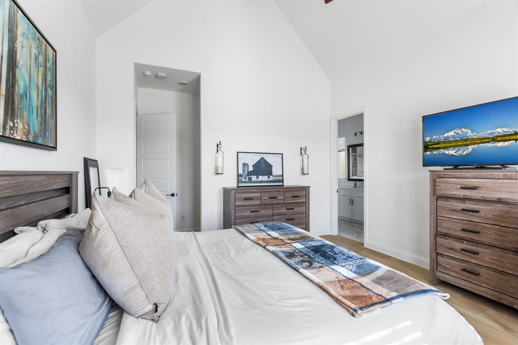 1898 Tumblegrass Road Frisco, TX 75033 - Photo 20 of 40 a bedroom with a bed and a view of living room