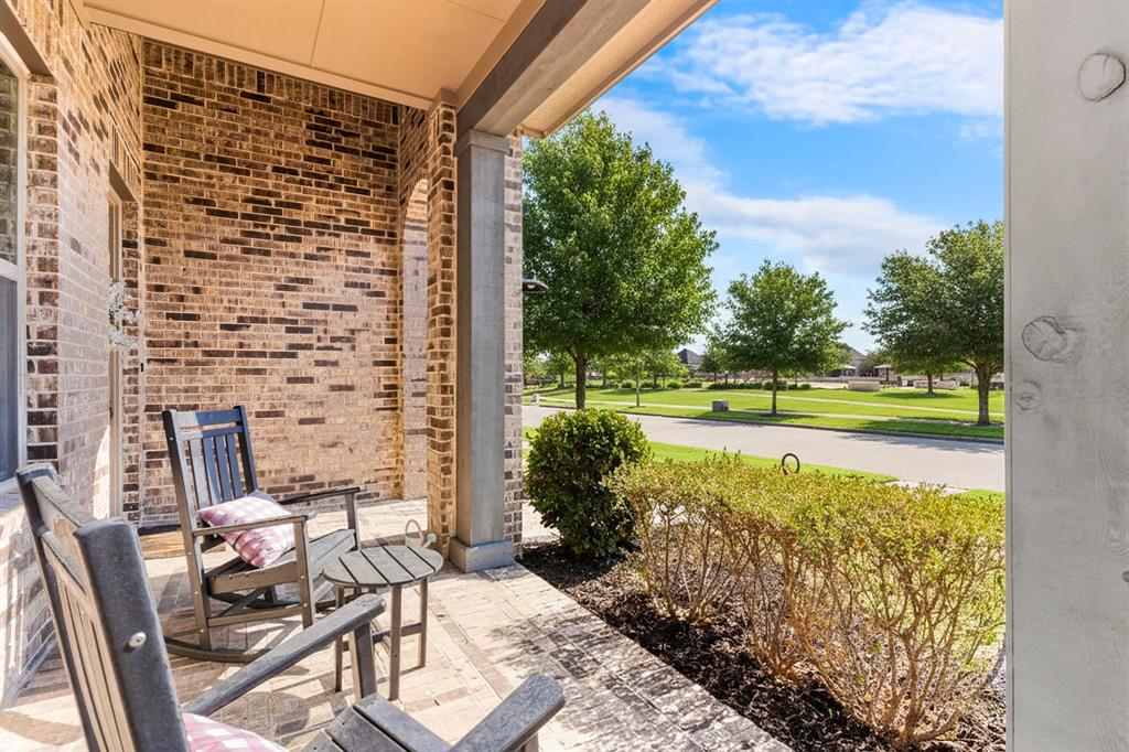 1898 Tumblegrass Road Frisco, TX 75033 - Photo 2 of 40 a view of a patio with table and chairs potted plants with lake view