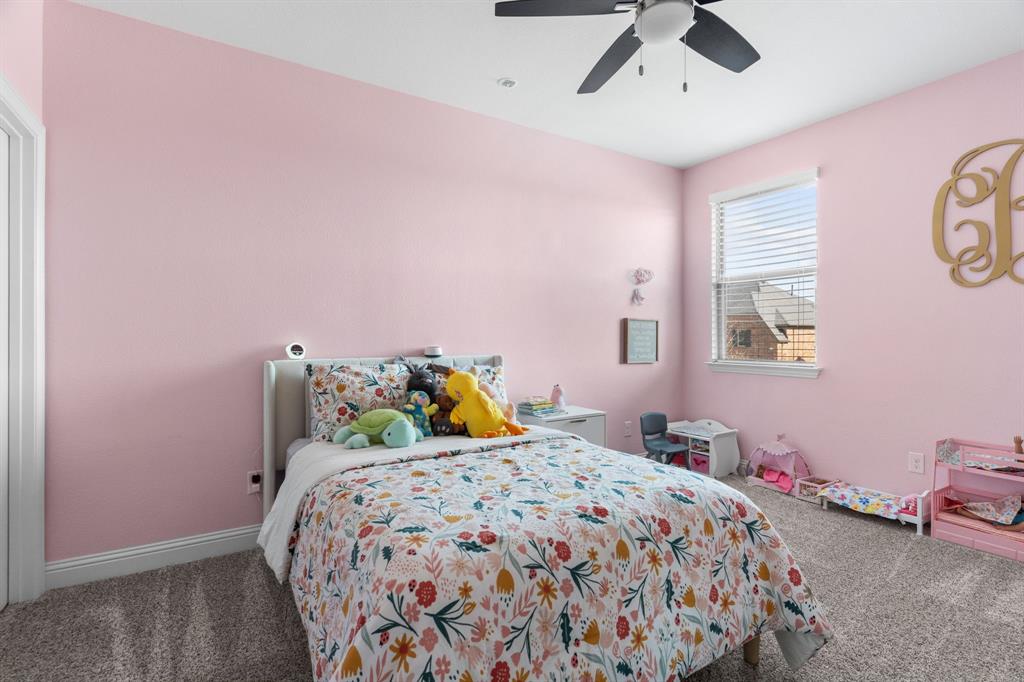 1898 Tumblegrass Road Frisco, TX 75033 - Photo 26 of 40 a bedroom with a bed and a chandelier