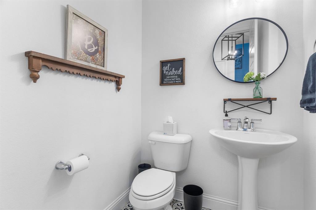 1898 Tumblegrass Road Frisco, TX 75033 - Photo 10 of 40 a bathroom with a toilet a sink and mirror
