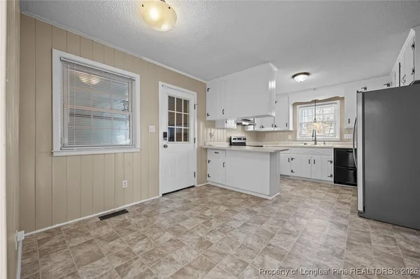 a kitchen with a sink stove and refrigerator