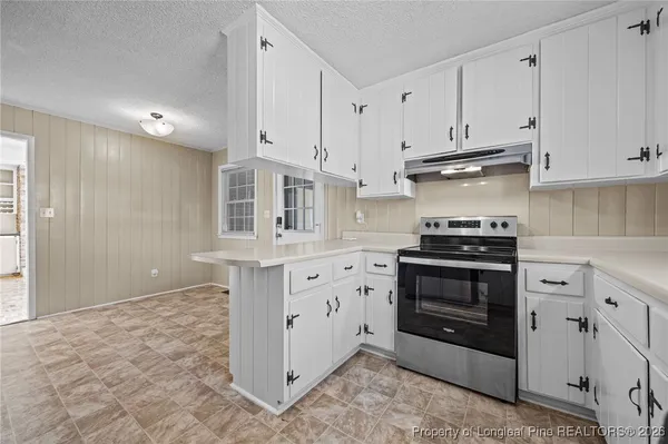a kitchen with stainless steel appliances a refrigerator sink and cabinets