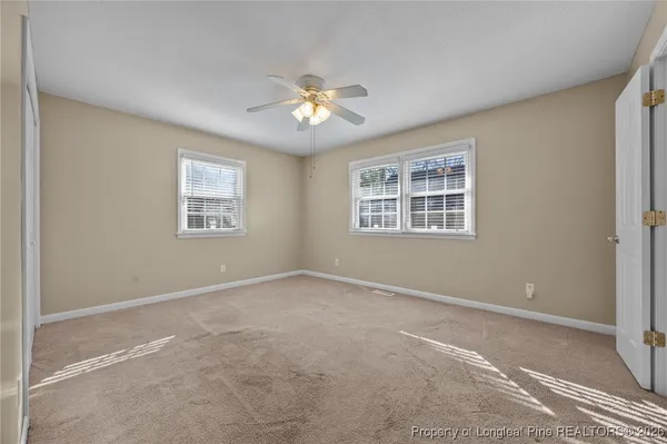 a view of a livingroom with a chandelier fan and closet area