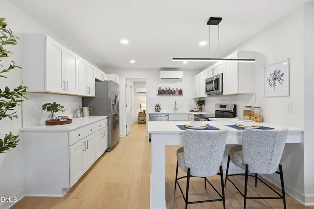 a kitchen with stainless steel appliances kitchen island granite countertop a sink and cabinets