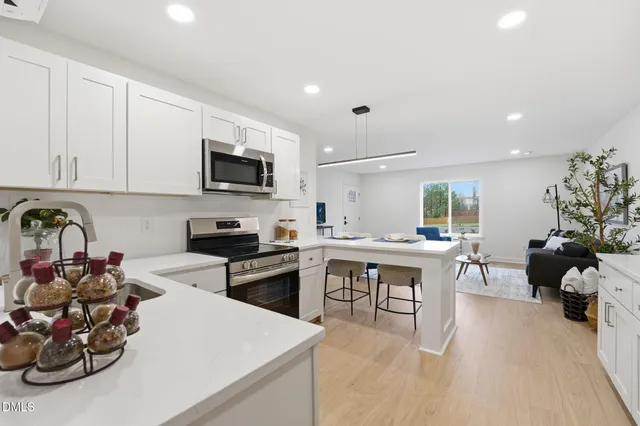 a kitchen with a sink stove and cabinets