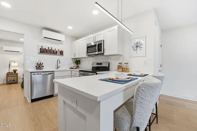 a kitchen with a stove a sink and a refrigerator