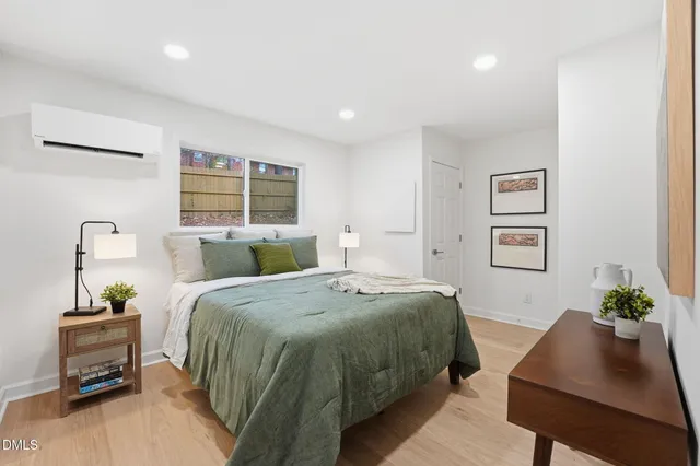 a spacious bedroom with a bed and a couch