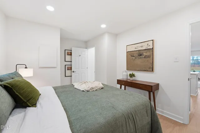 a bedroom with a bed and a mirror